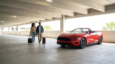 Modern vehicles lined up in a bright Orlando airport parking garage for car rental