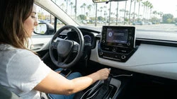 Driver connecting a smartphone to the dashboard USB port of a California car rental